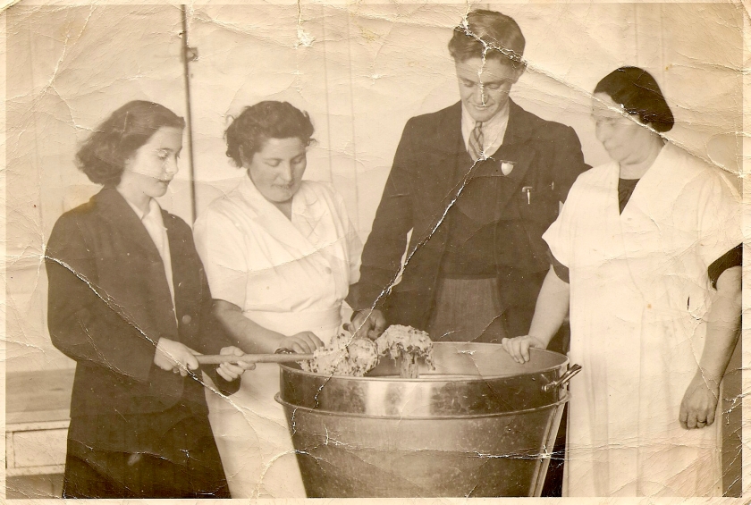 A man and three women with a large bowl of cake mix