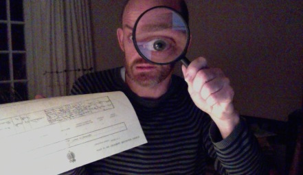 Man holding magnifying glass and death certificate