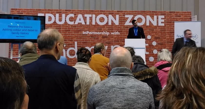 Myko Clelland (FindMyPast), presenting in the Education Zone.